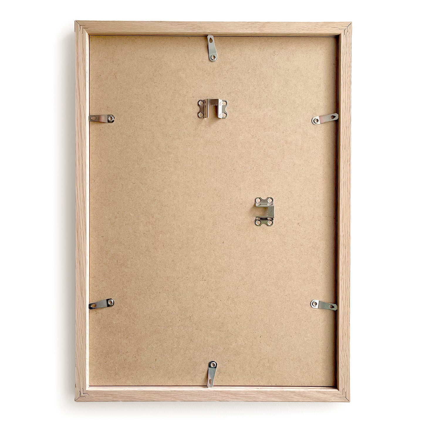 Back view of a wooden picture frame with mounting hardware on a white background