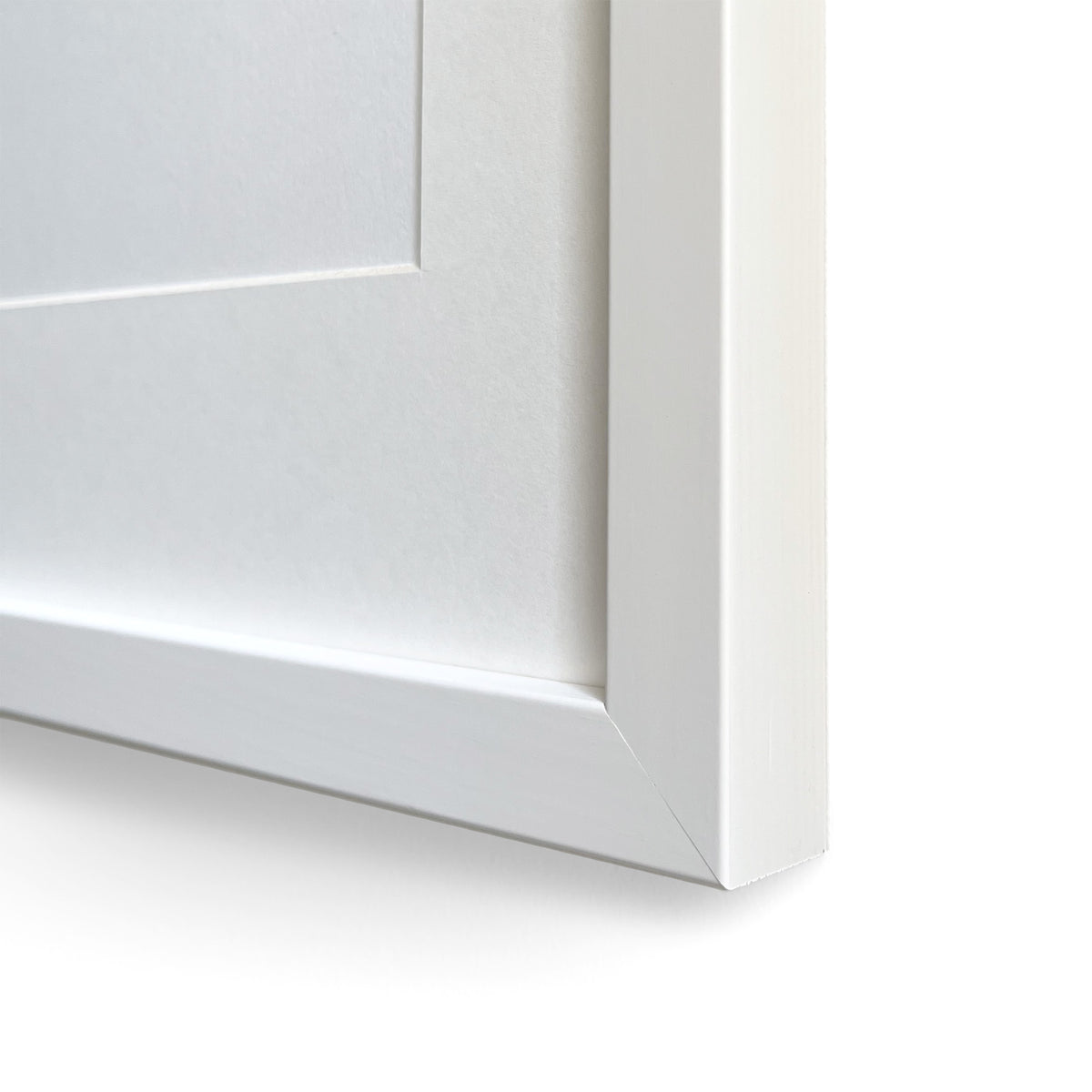 Close-up of a white frame corner with pass-partout on a white background