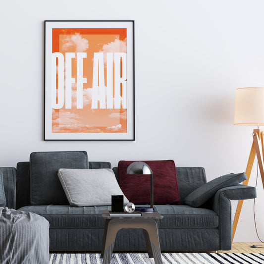 orange interior poster with a background of clouds and the inscription off air in a living room