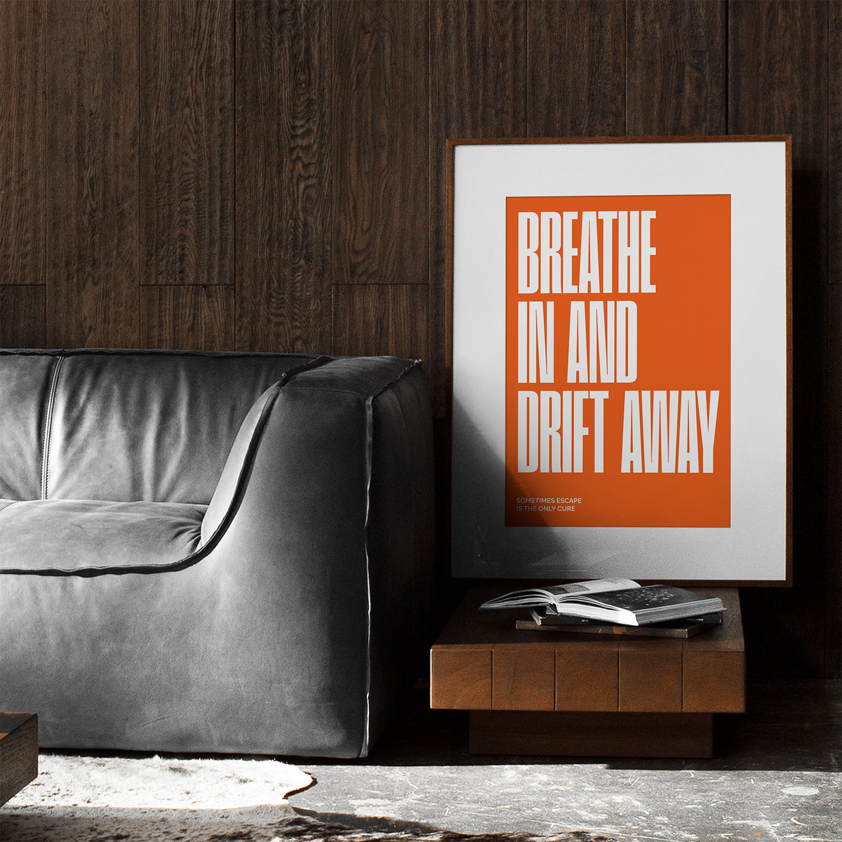 orange interior poster with the inscription breathe in and drift away in a dark living room wall art by Levӧ