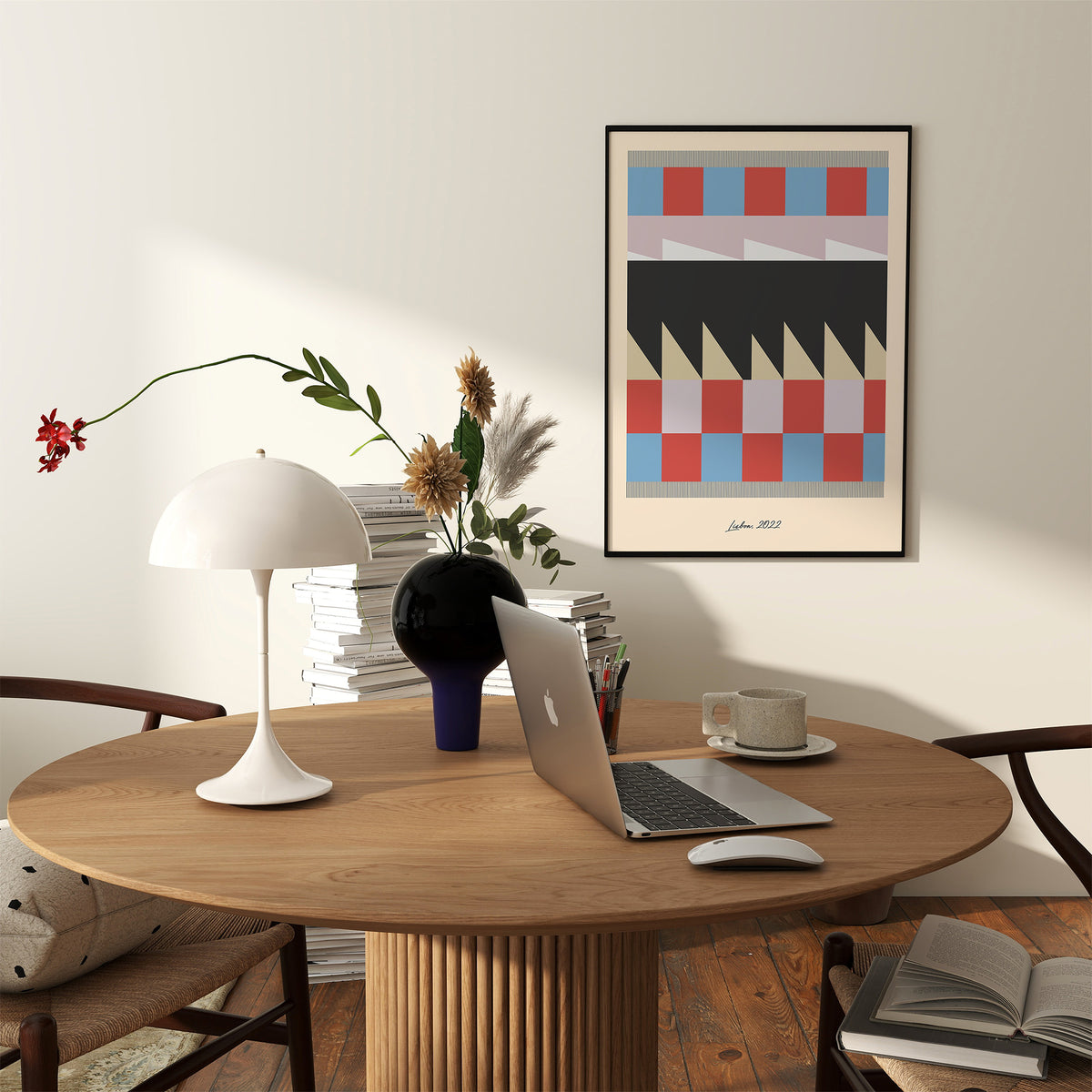 Modern office setup with a wooden desk, laptop, and decorative items.