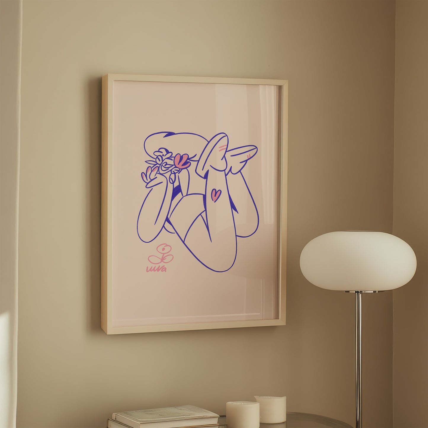 Framed artwork of a stylized woman holding flowers on a beige wall with a lamp in the corner.