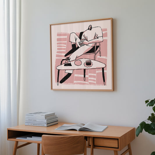 Framed pint artwork on a wall above a wooden desk with books and an open magazine.