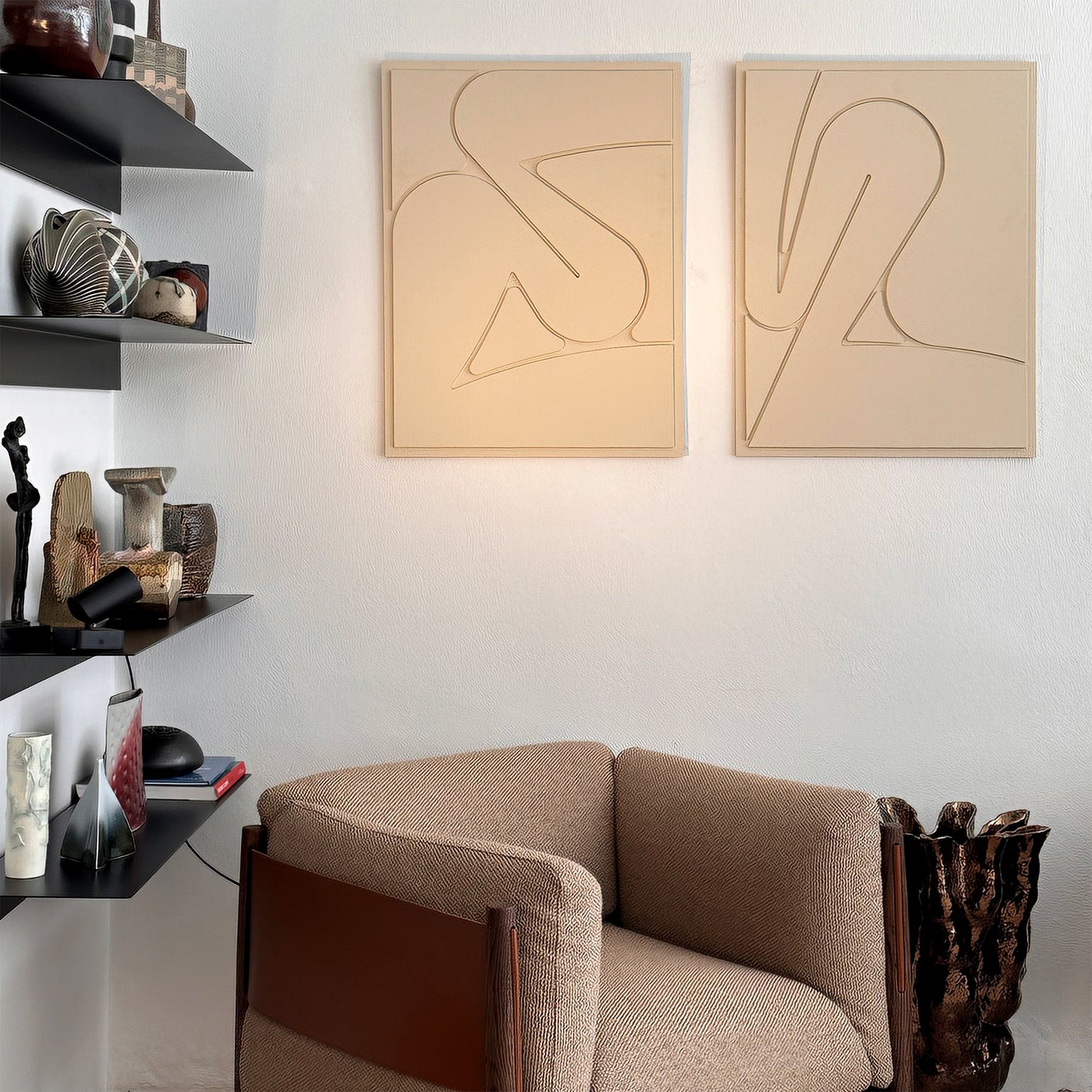 Two wall art reliefs on the wall n an art gallery