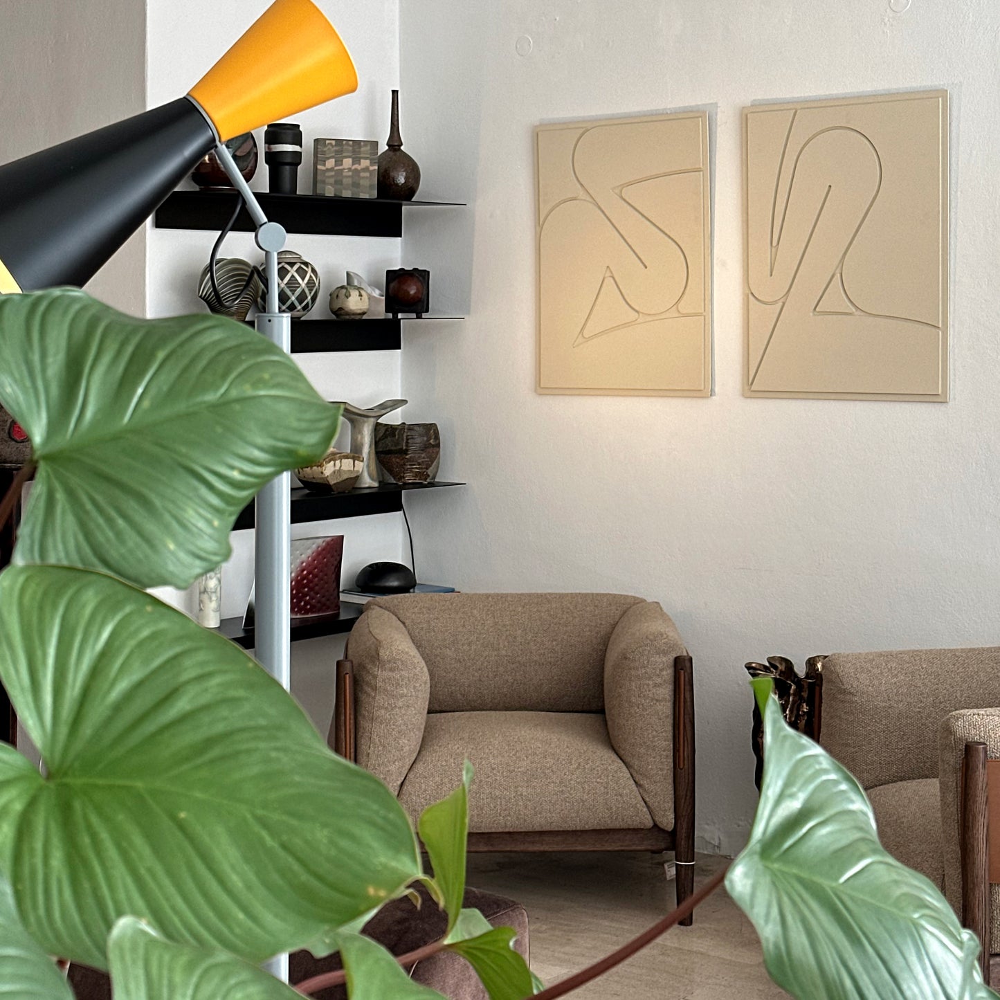 Two wall art reliefs on the wall in a furniture store