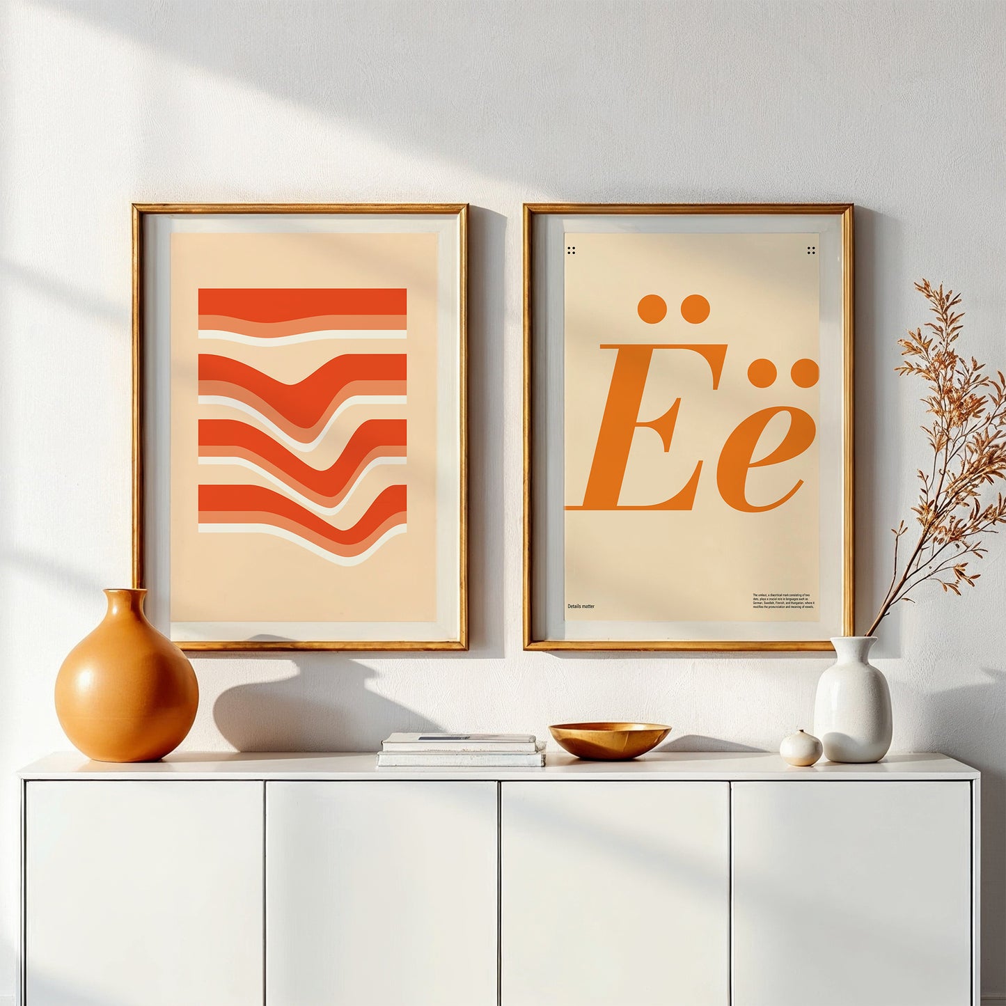 Two wall posters with orange shades on the wall