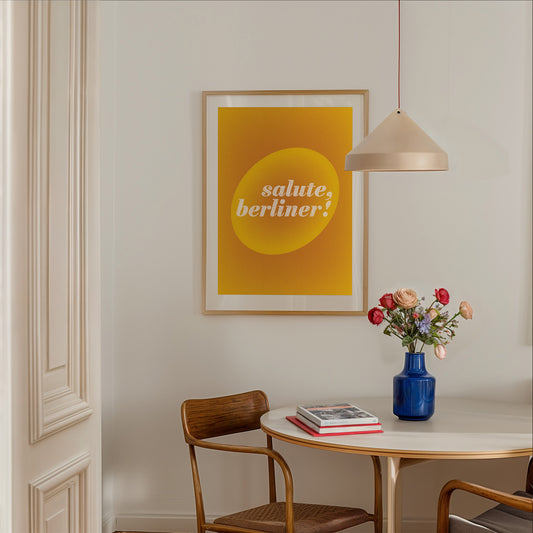 Abstract interior poster in yellow-gold with sign Salute, Berliner in a dining room