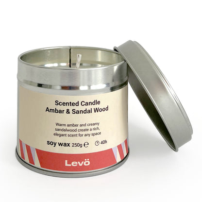 Scented candle in a metal tin with 'Levo' branding on a white background
