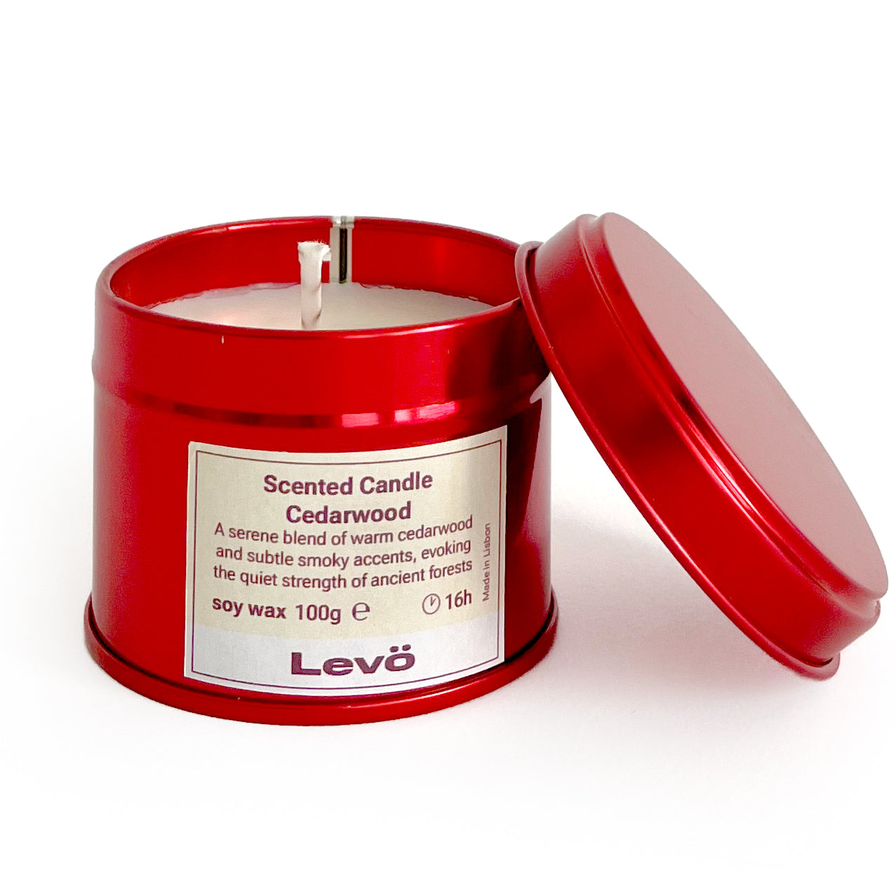 Red tin candle with a white candle inside, labeled 'Levo' on a white background