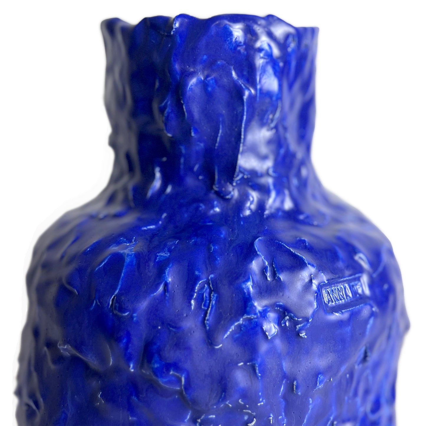 Blue textured glass bottle with 'Rocca' branding on a white background