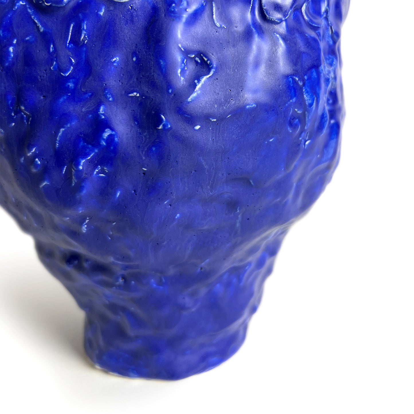 Blue textured vase on a white background