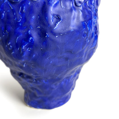 Blue textured vase on a white background