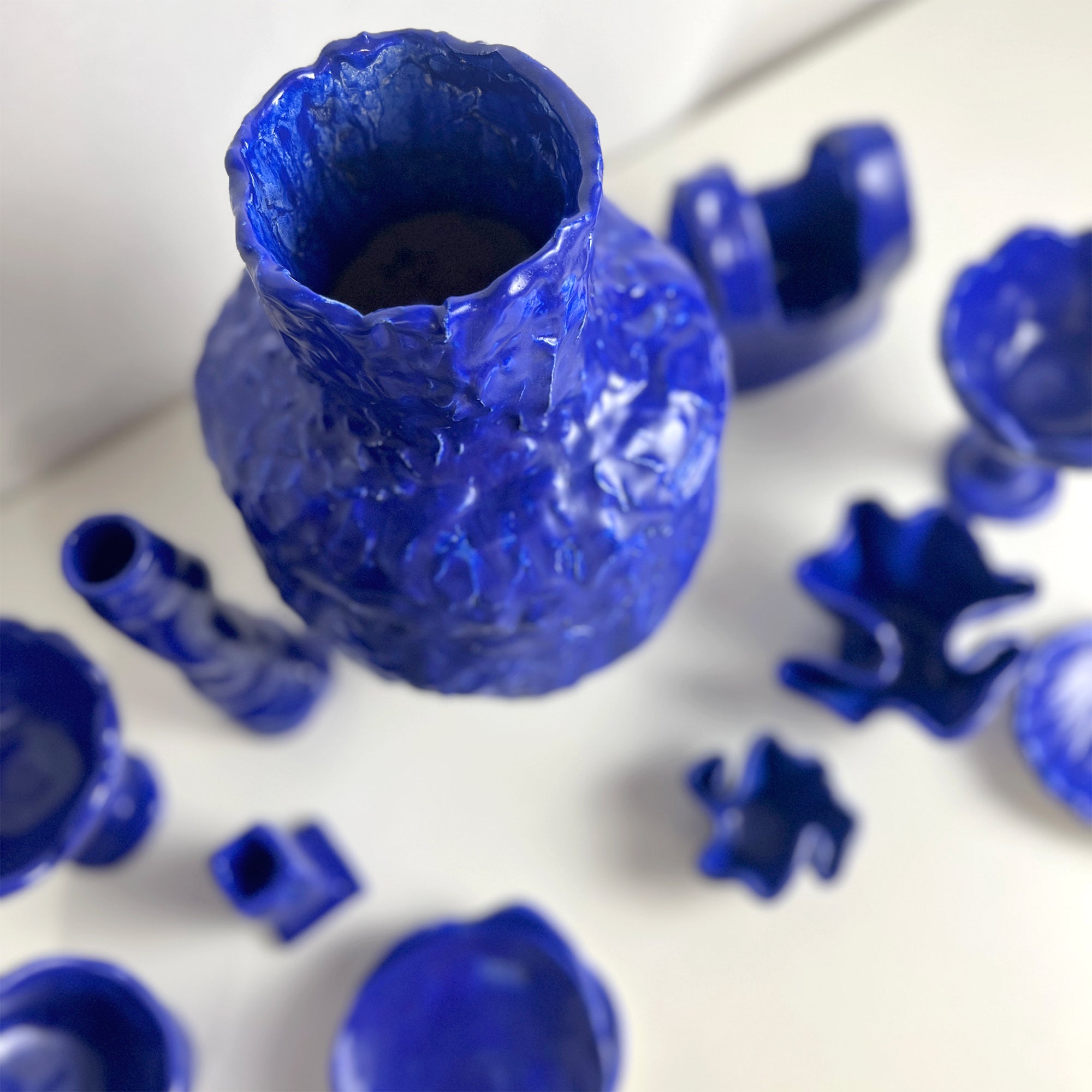 Blue plastic mold parts on a white background