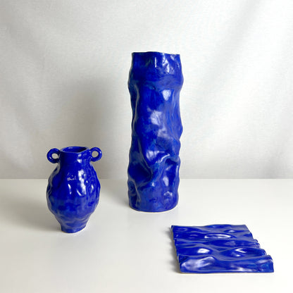 Set of three blue ceramic vases by Anna Demidova for Levö on a white background