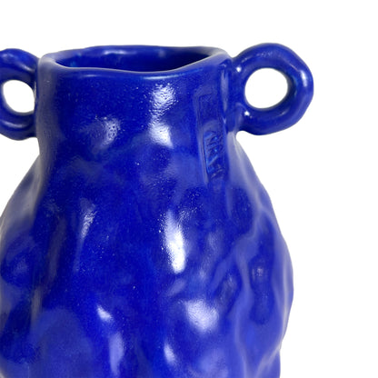 Blue ceramic vase with two handles on a white background