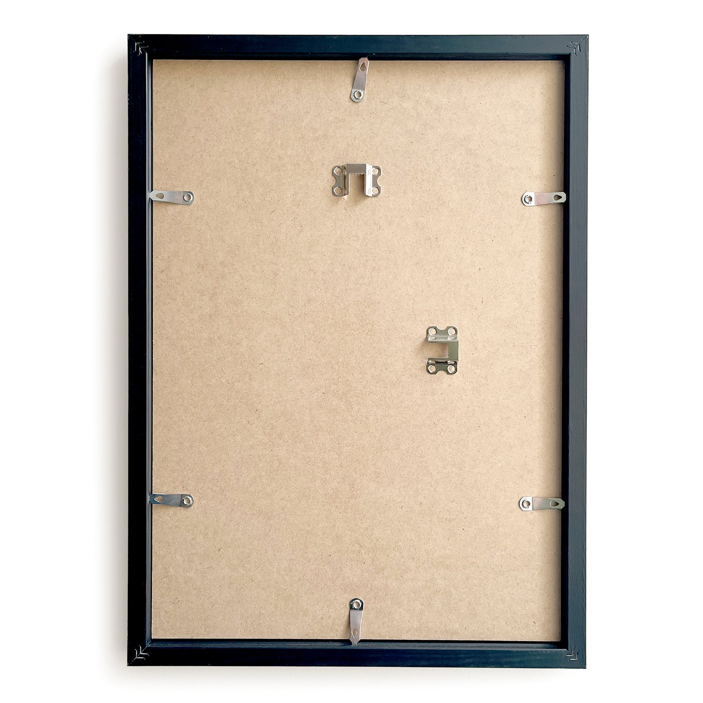 Backside of a black picture frame with mounting hardware on a beige background