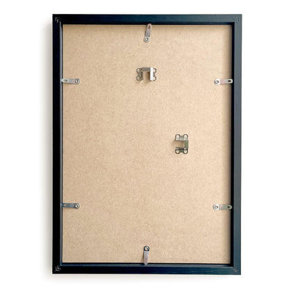 Backside of a black picture frame with mounting hardware on a beige background