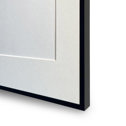 Close-up of a black aluminium picture frame corner on a white background