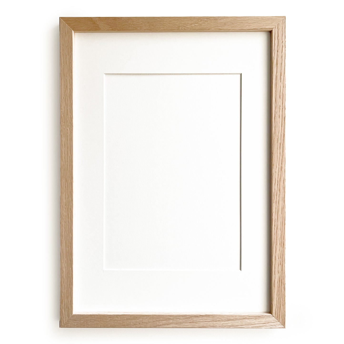 Wooden picture frame by Levö on a white background