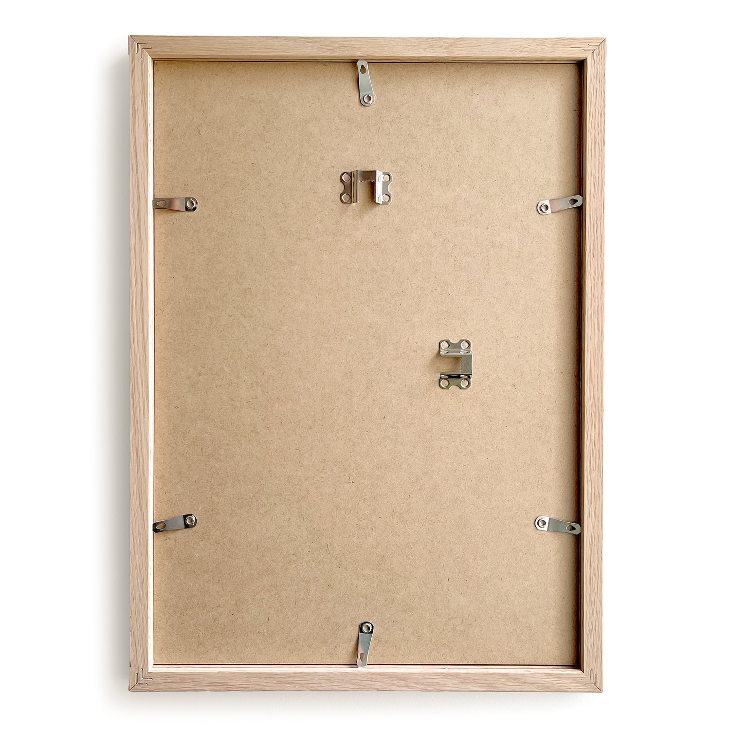Back view of a wooden picture frame with mounting hardware on a white background