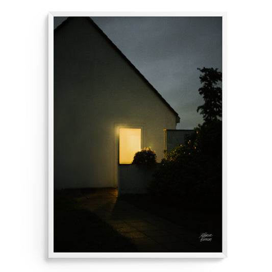 Fine art Photography showing house with a single light on in the dark