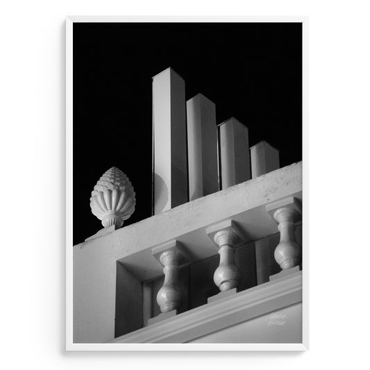 Photography art in Black and white of architectural detail of a building facade with columns and decorative elements.