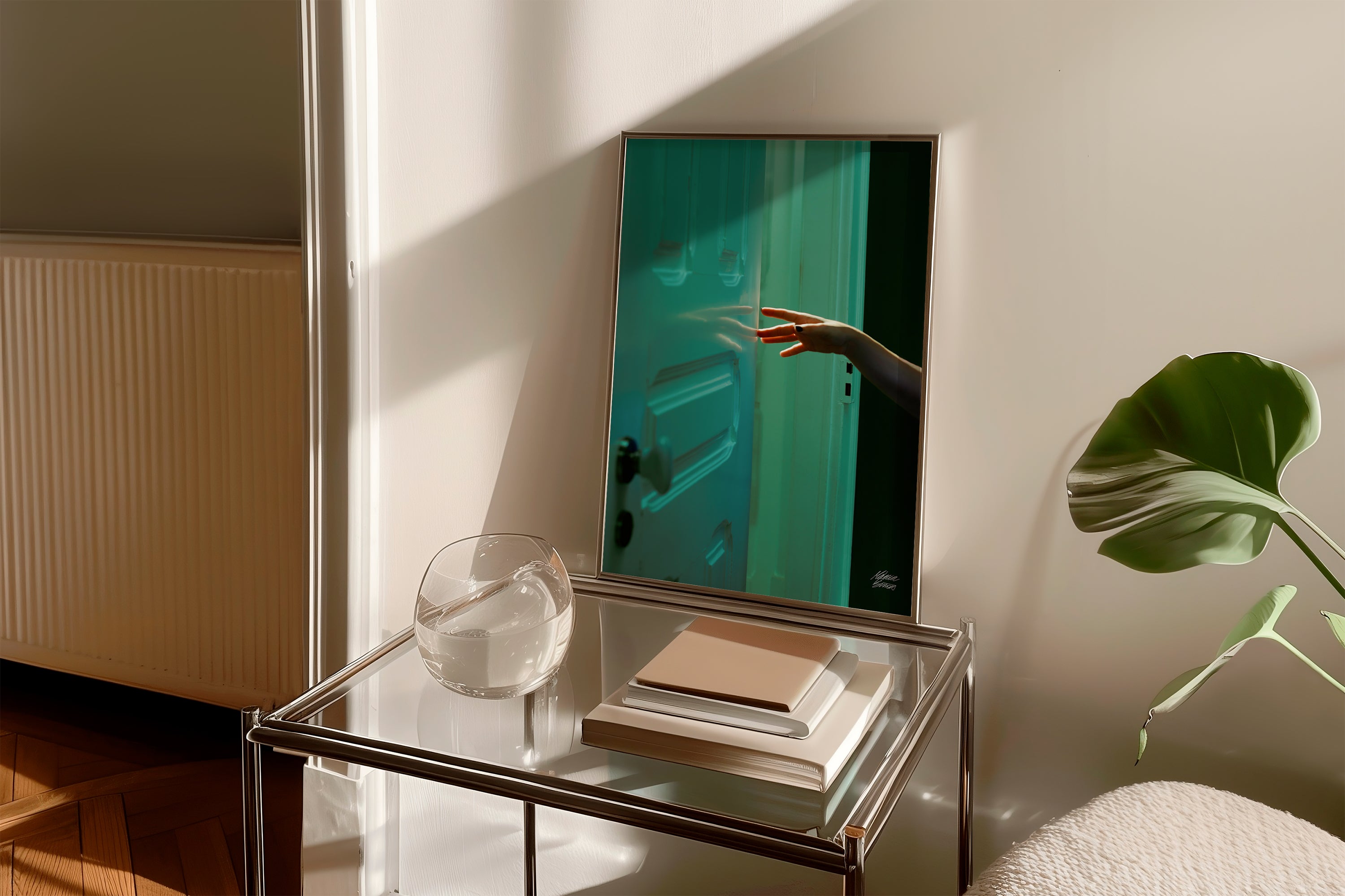 Fine Art Photography at modern interior with a glass table, plant, and reflective wall surface.