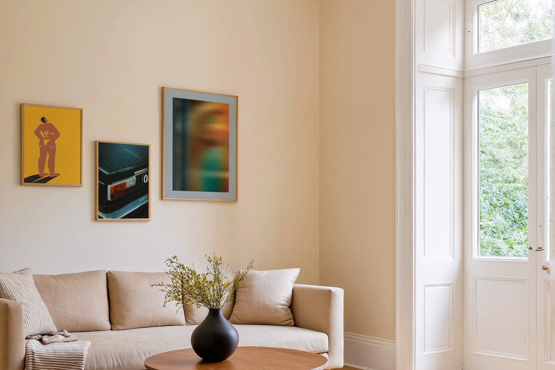 three posters by Levö on the wall in a living room in scandinavian style