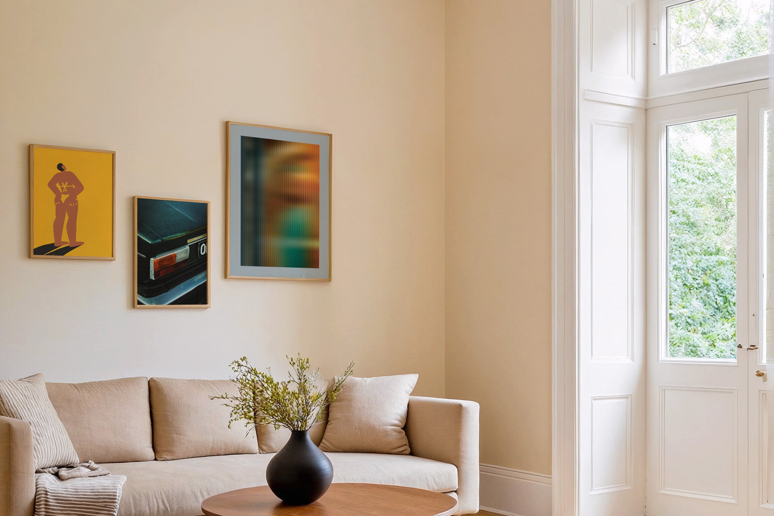 three posters by Levö on the wall in a living room in scandinavian style