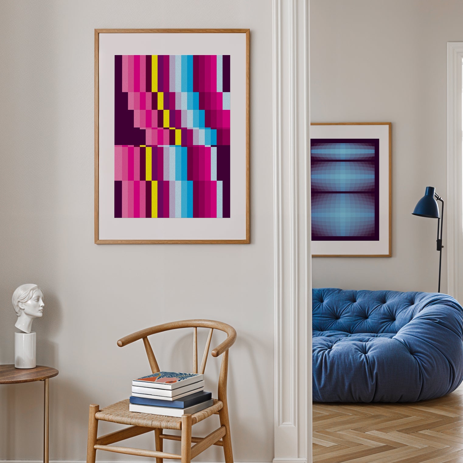 Modern interior with bright abstract posters, chair, and blue sofa.