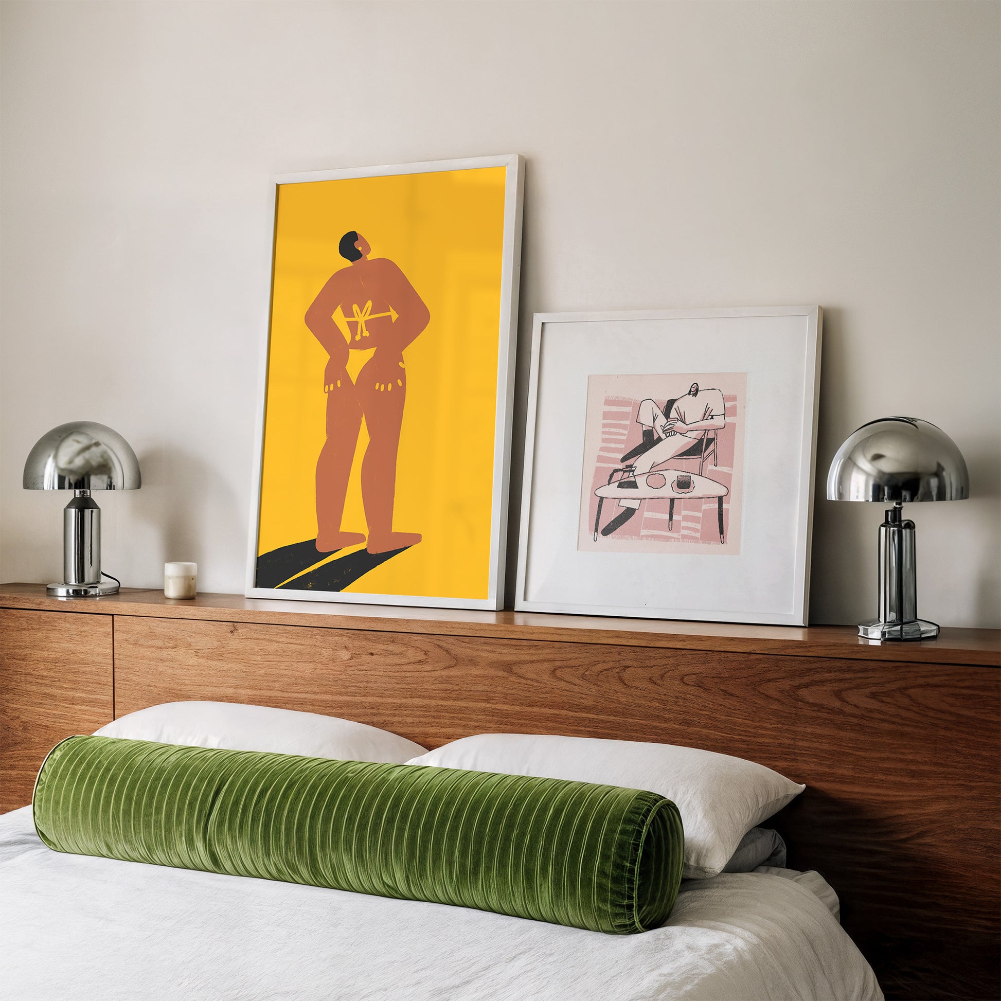 Bedroom with wooden headboard, green cylindrical pillow, and framed artwork on a white wall.