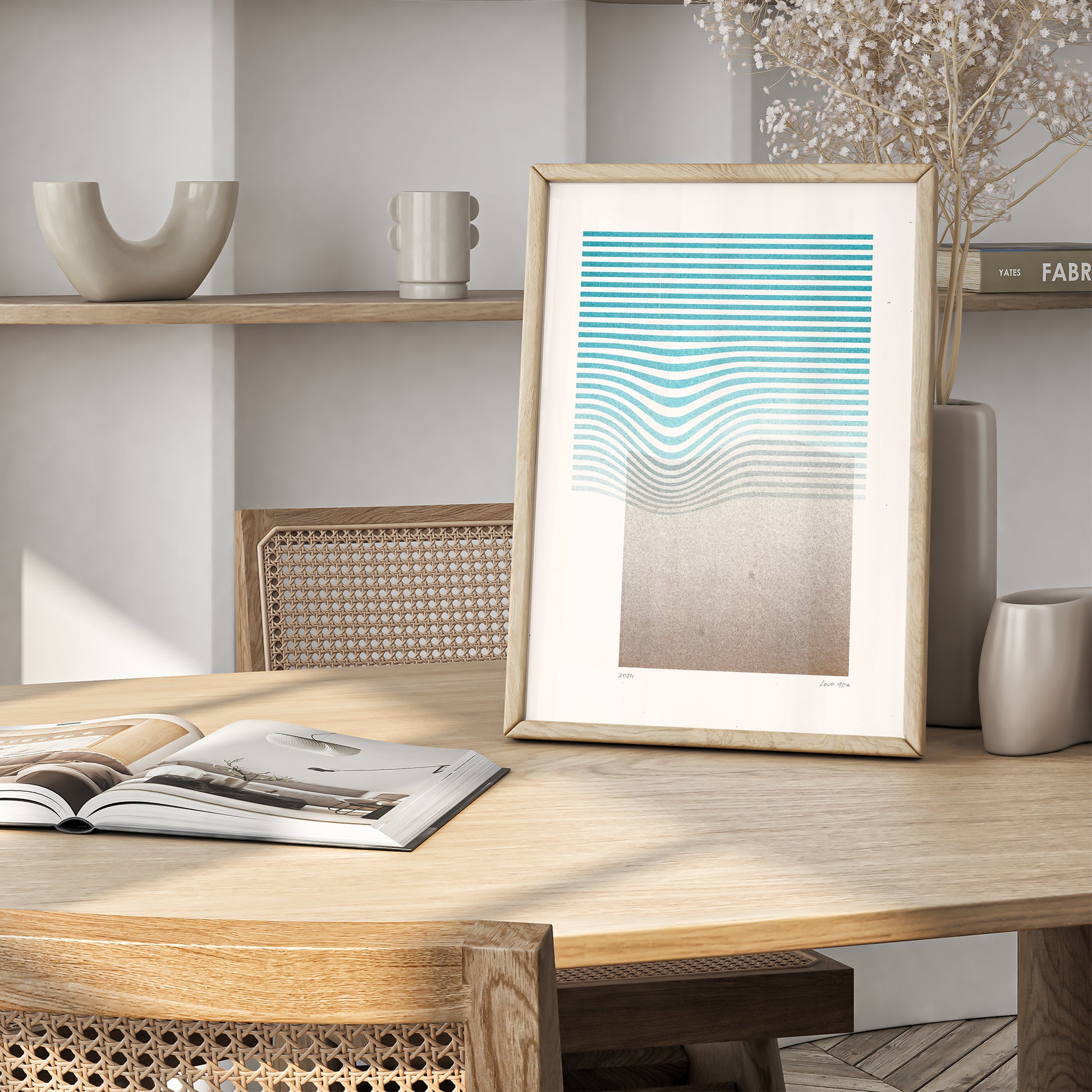 Limited edition poster Volna in teal and gold in a wooden frame on the table