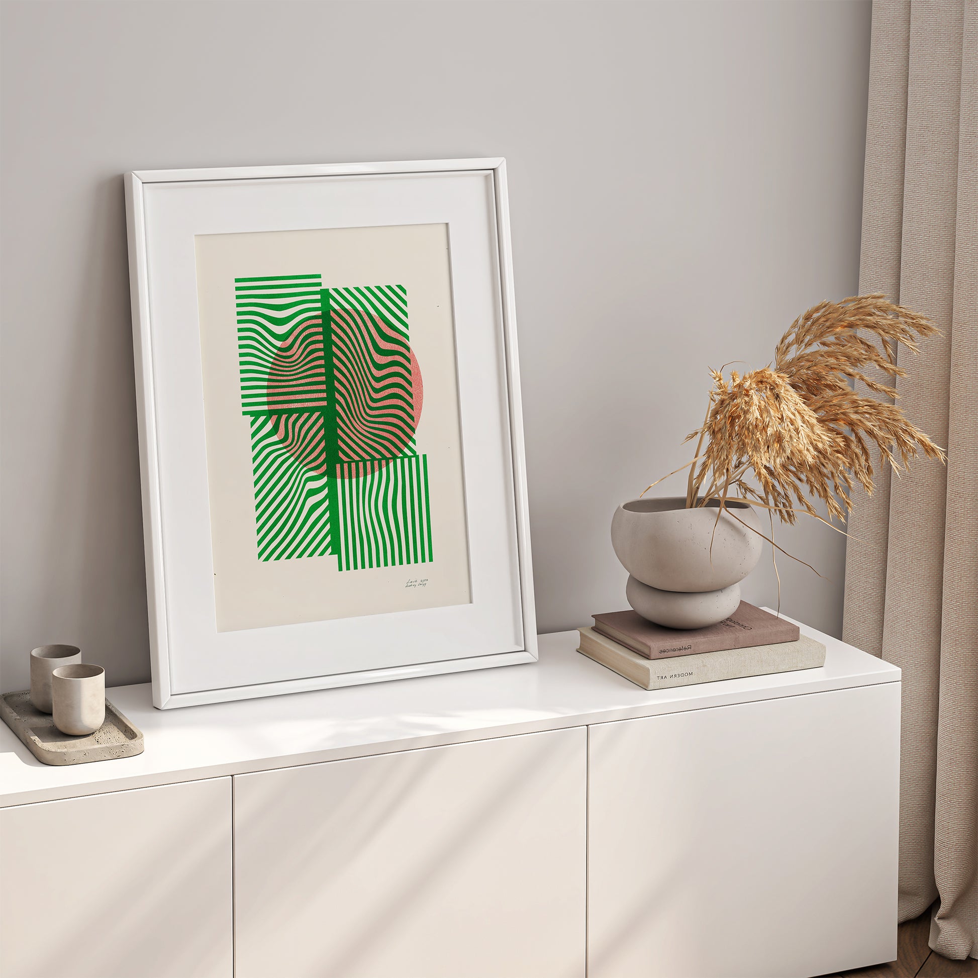 Limited edition poster Volna in green and orange in a white frame on a shelve