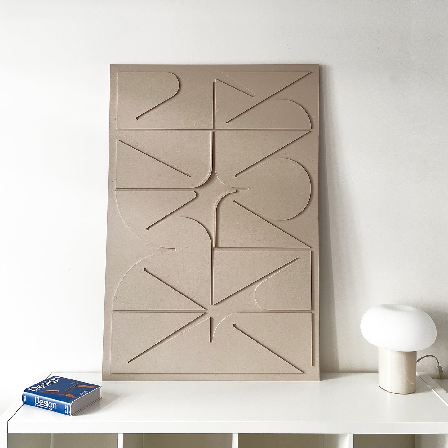 Sculptural Wall relief in beige on the white wall