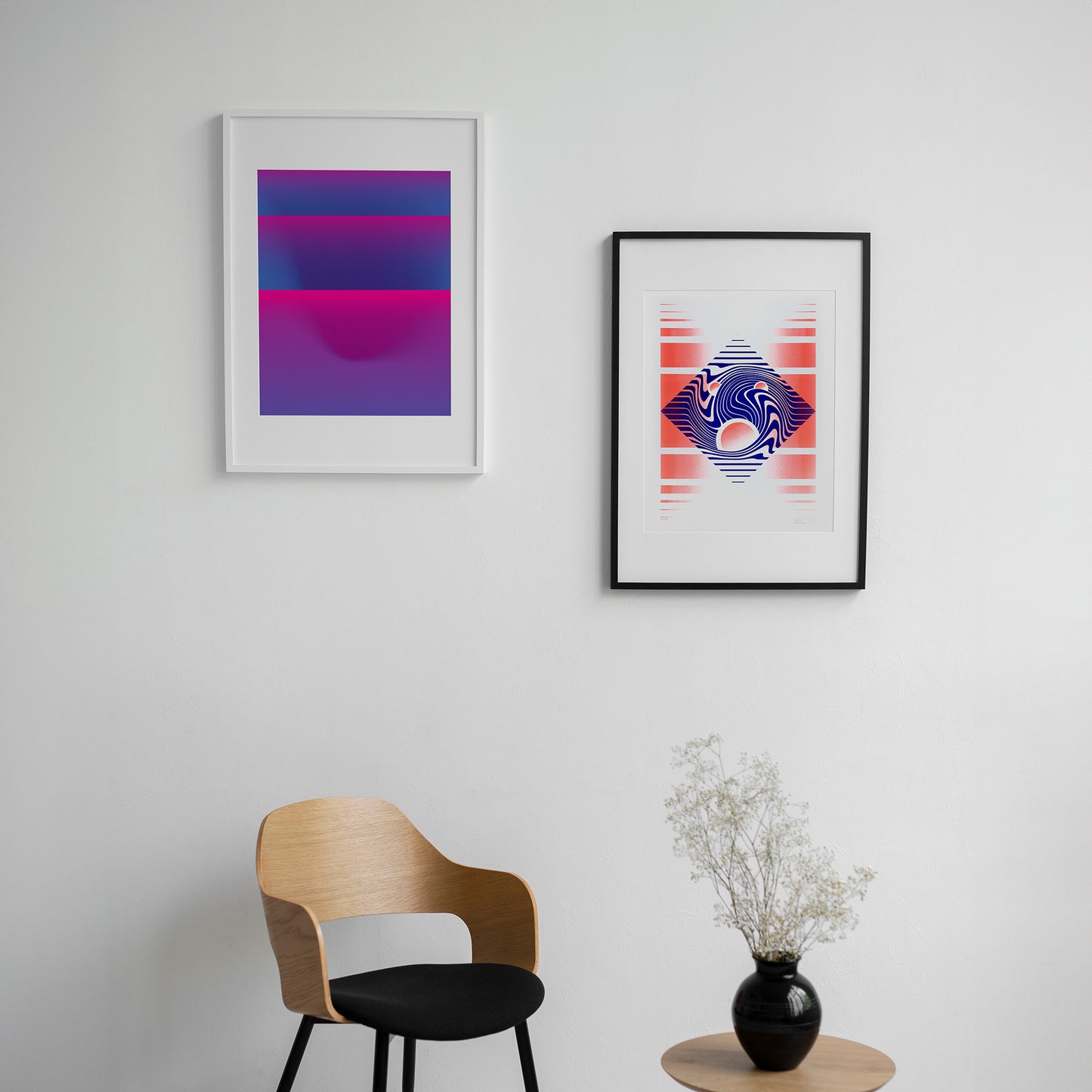 two blue posters by Levö in frames on the wall