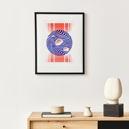 Limited edition riso poster in blue and fluor orange in a black frame on the white wall