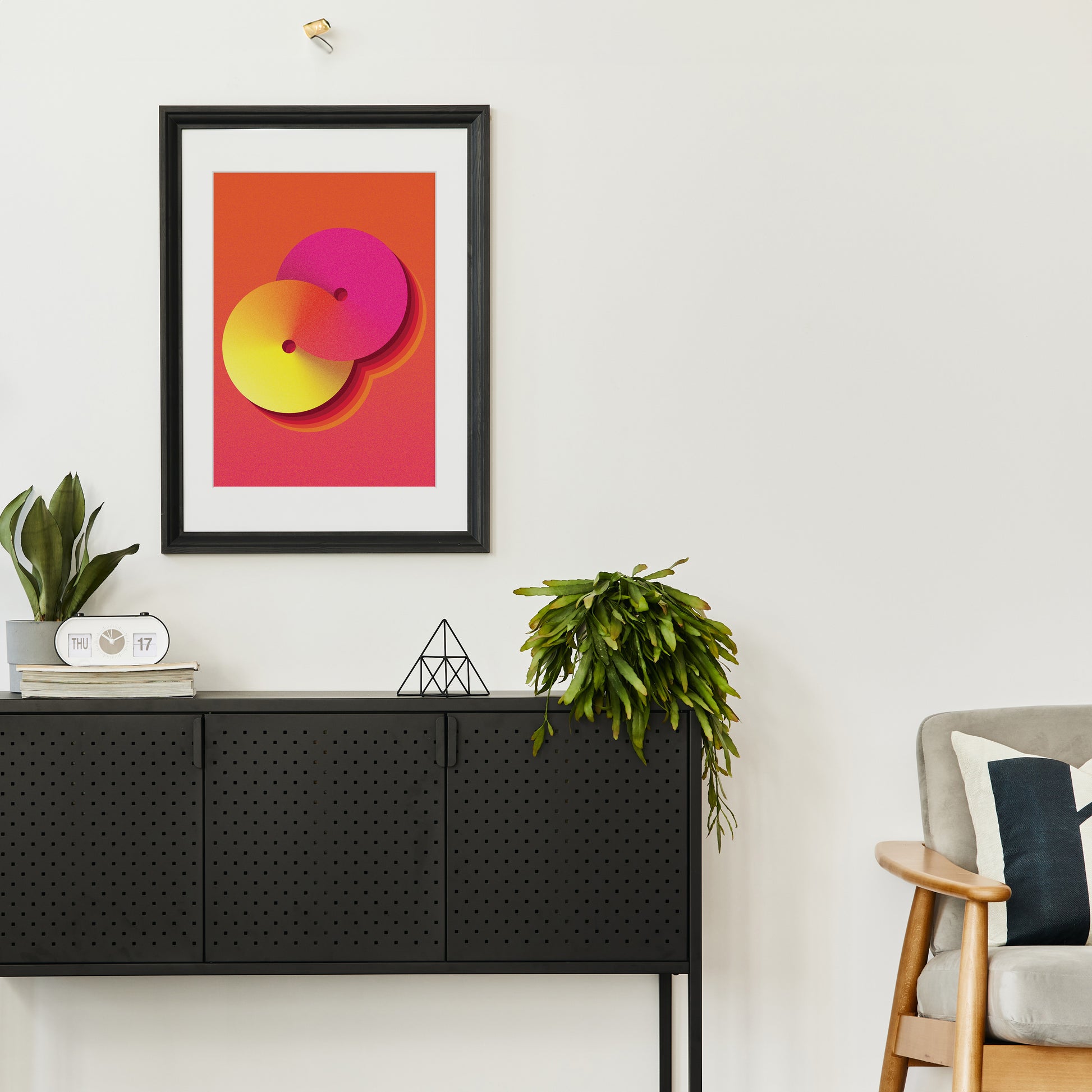 yellow-orange interior poster with geometric shape in a black frame on the wall