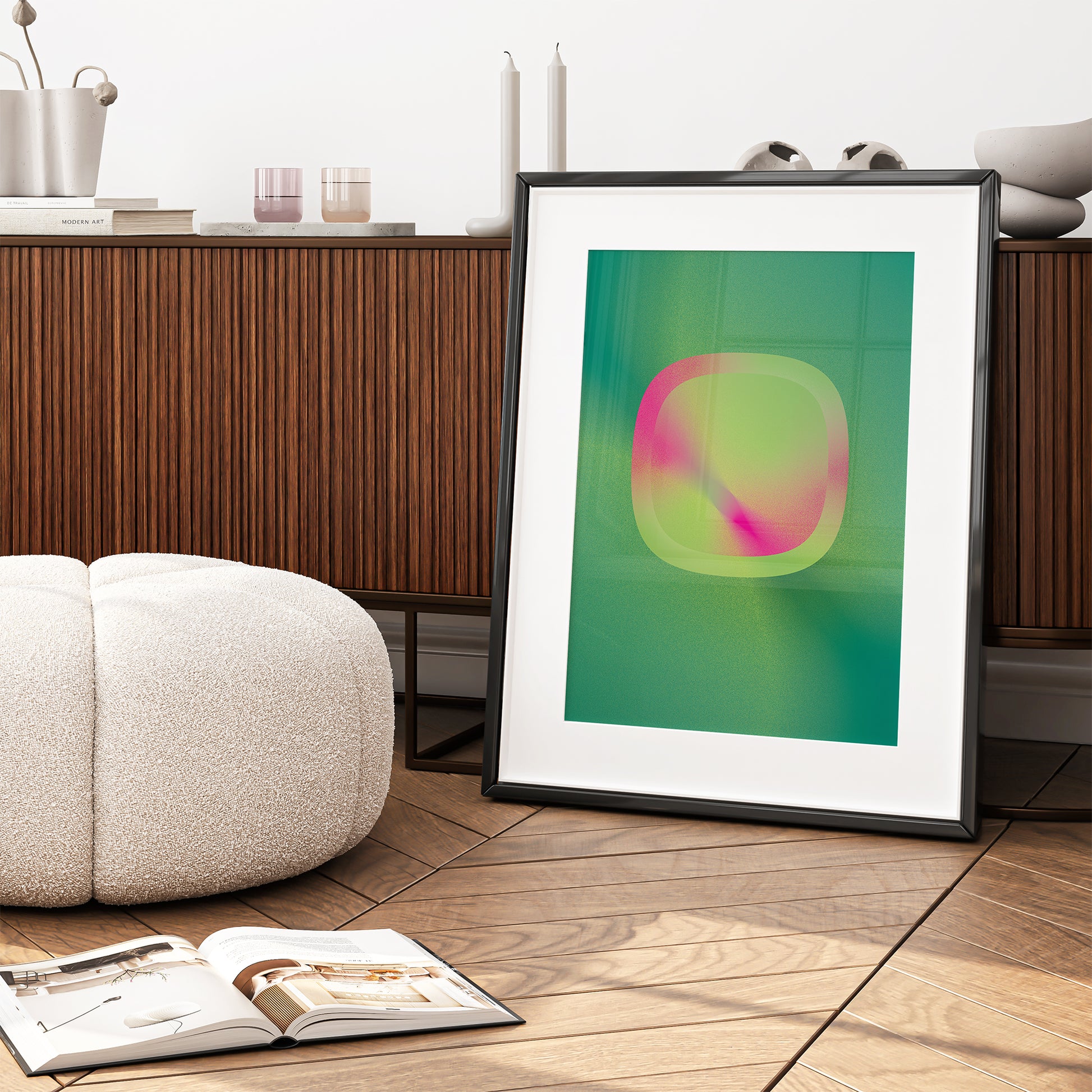 Green-pink interior poster with geometric shape in a black frame in a living room