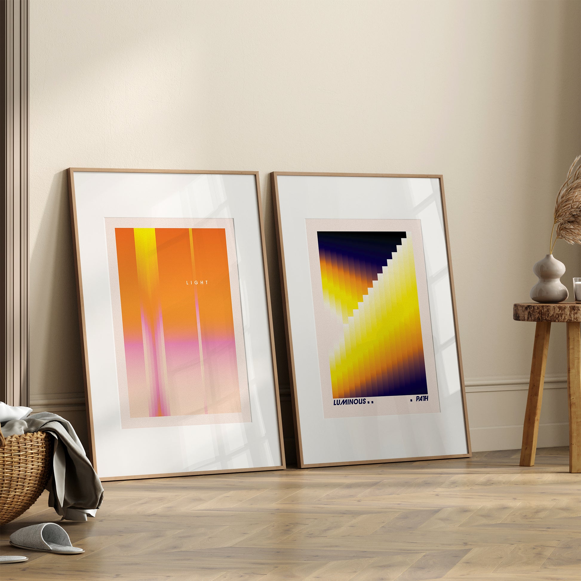 Two framed abstract artworks on a wall in a room with a wooden floor.
